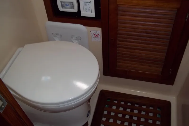 Trouvaille Yacht Photos Pics 1984 Slocum 43 yacht bathroom with toilet and wooden cabinet.