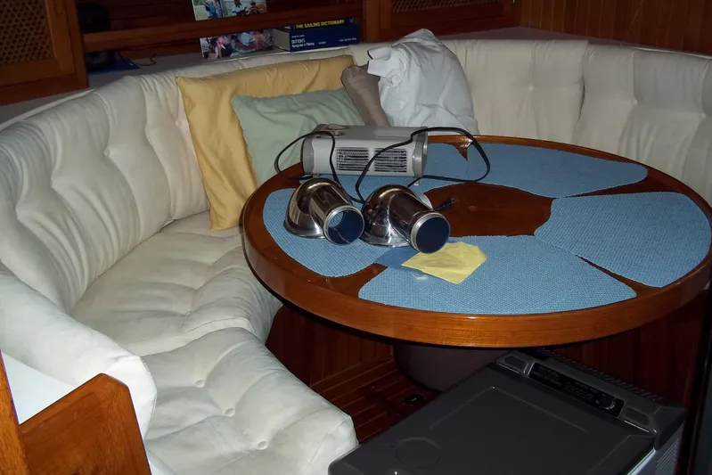 Trouvaille Yacht Photos Pics Cozy interior of 1984 Slocum 43 yacht with round table and cushioned seating.