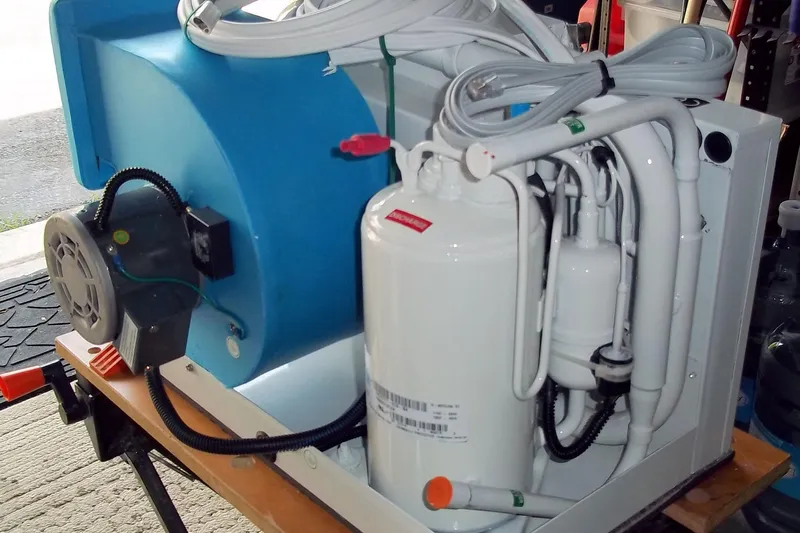 Trouvaille Yacht Photos Pics Marine air conditioning unit for a 1984 Slocum 43 sailboat, featuring white and blue components.