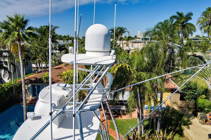  Yacht Photos Pics 2008 Viking 74 Enclosed Bridge yacht with radar, surrounded by tropical palm trees.