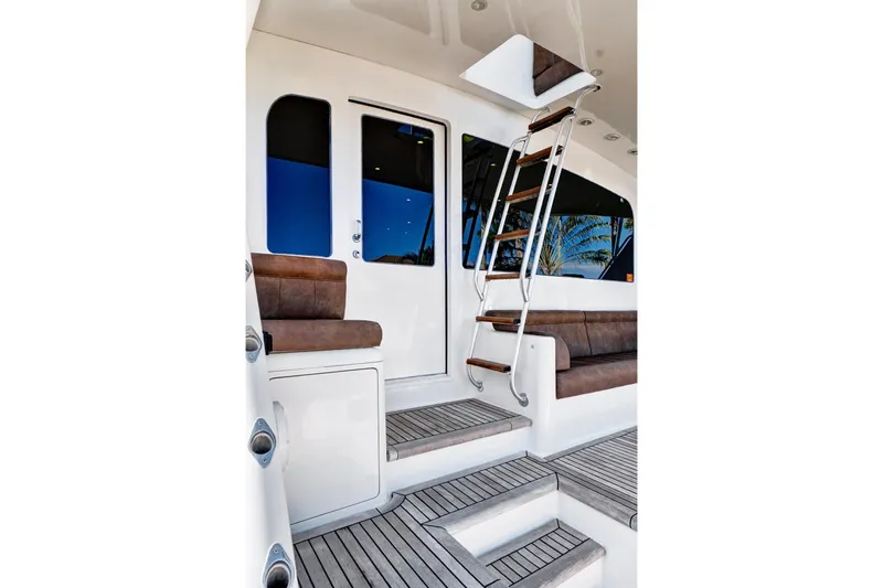  Yacht Photos Pics 2008 Viking 74 Enclosed Bridge yacht interior with wooden steps and seating.