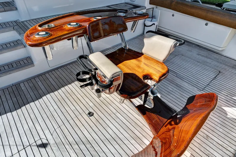  Yacht Photos Pics Luxurious teak fishing chair on 2008 Viking 74 Enclosed Bridge yacht deck.