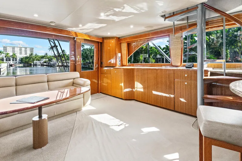  Yacht Photos Pics Luxurious interior of 2008 Viking 74 Enclosed Bridge yacht with elegant wood finishes.