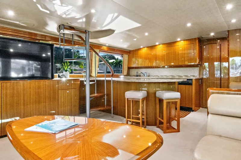  Yacht Photos Pics Luxurious interior of 2008 Viking 74 Enclosed Bridge yacht with modern kitchen and seating.