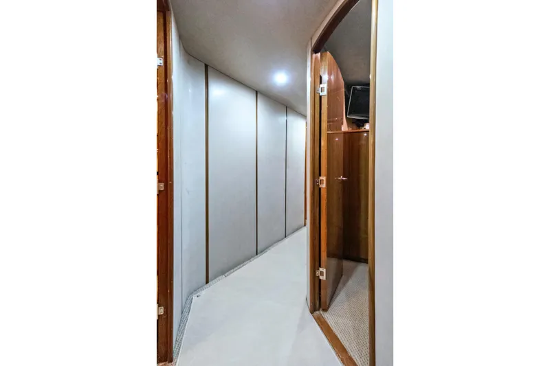  Yacht Photos Pics Hallway inside 2008 Viking 74 Enclosed Bridge yacht, featuring wooden doors and modern lighting.