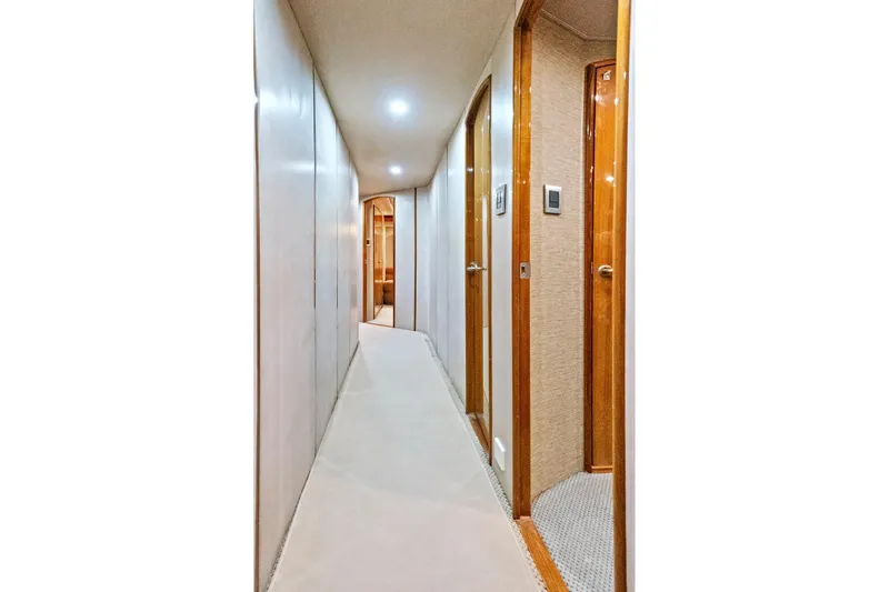  Yacht Photos Pics Hallway inside 2008 Viking 74 Enclosed Bridge yacht, featuring wooden doors and soft lighting.