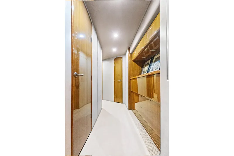  Yacht Photos Pics Luxurious hallway inside 2008 Viking 74 Enclosed Bridge yacht, featuring wooden doors and elegant lighting.