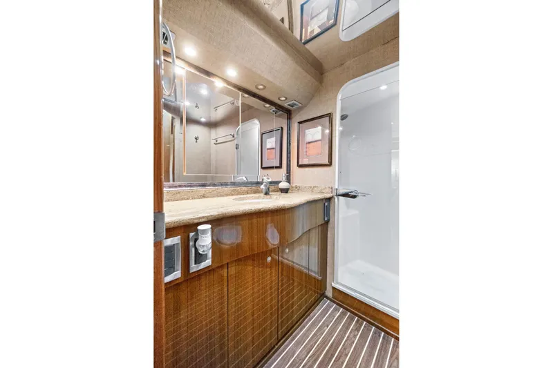  Yacht Photos Pics Luxurious bathroom in 2008 Viking 74 Enclosed Bridge yacht with wood accents and modern fixtures.