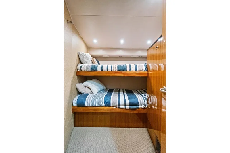  Yacht Photos Pics Bunk beds in 2008 Viking 74 Enclosed Bridge yacht cabin with striped bedding.
