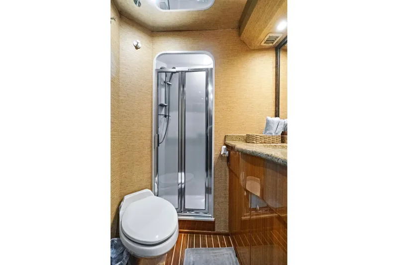  Yacht Photos Pics Luxurious bathroom in 2008 Viking 74 Enclosed Bridge yacht with shower and wooden accents.