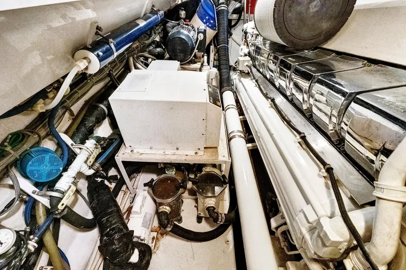  Yacht Photos Pics Engine room of 2008 Viking 74 Enclosed Bridge yacht, showcasing mechanical components and piping.
