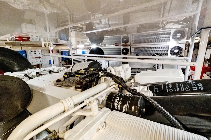  Yacht Photos Pics Engine room of 2008 Viking 74 Enclosed Bridge yacht, showcasing mechanical components and systems.