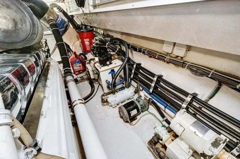  Yacht Photos Pics Engine room of 2008 Viking 74 Enclosed Bridge yacht, showcasing mechanical components and wiring.