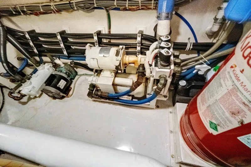  Yacht Photos Pics Engine room of 2008 Viking 74 Enclosed Bridge with machinery and fire extinguisher.