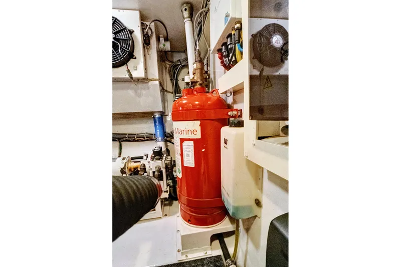  Yacht Photos Pics Engine room of 2008 Viking 74 Enclosed Bridge with red marine fire extinguisher.