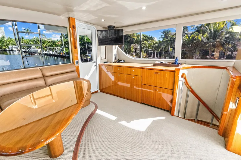  Yacht Photos Pics Luxurious interior of 2008 Viking 74 Enclosed Bridge yacht with elegant wood finishes.
