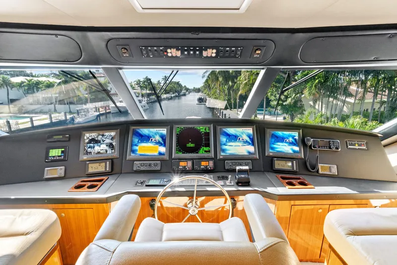  Yacht Photos Pics 2008 Viking 74 Enclosed Bridge yacht helm with advanced navigation systems and luxurious seating.