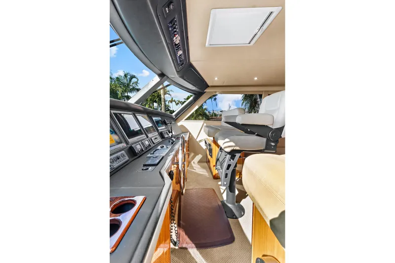  Yacht Photos Pics 2008 Viking 74 Enclosed Bridge helm with modern controls and comfortable seating.