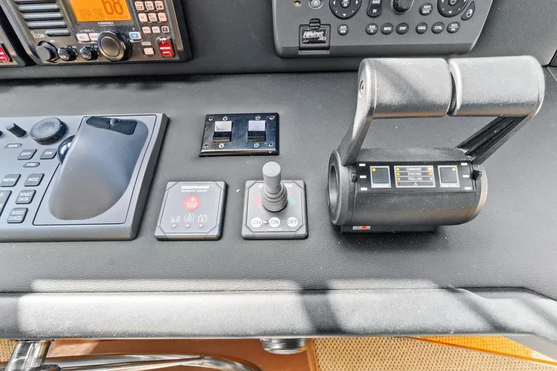  Yacht Photos Pics Control panel of 2008 Viking 74 Enclosed Bridge yacht with navigation and throttle controls.
