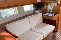 2020 Bavaria C45 yacht interior with cozy seating and navigation station.