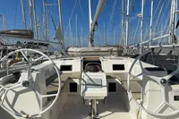 2020 Bavaria C45 yacht cockpit with dual steering wheels in a marina setting.