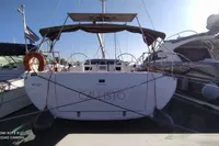2020 Bavaria C45 yacht docked at marina, rear view with clear sky.