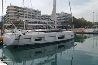 2020 Bavaria C45 yacht docked in a marina with cityscape background.