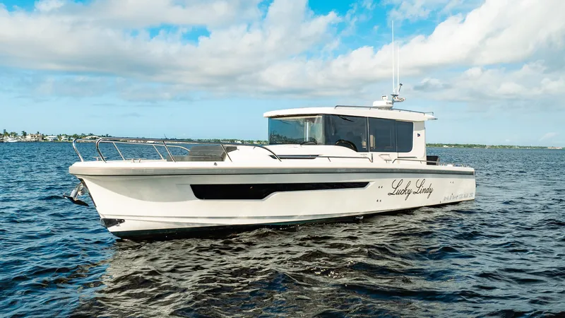 Lady Lindy Yacht Photos Pics Nimbus C-11 2021 boat cruising on open water under a partly cloudy sky.