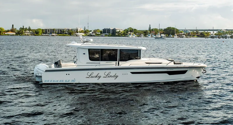Lady Lindy Yacht Photos Pics 2021 Nimbus C-11 boat named "Lucky Lindy" cruising on a calm waterway.