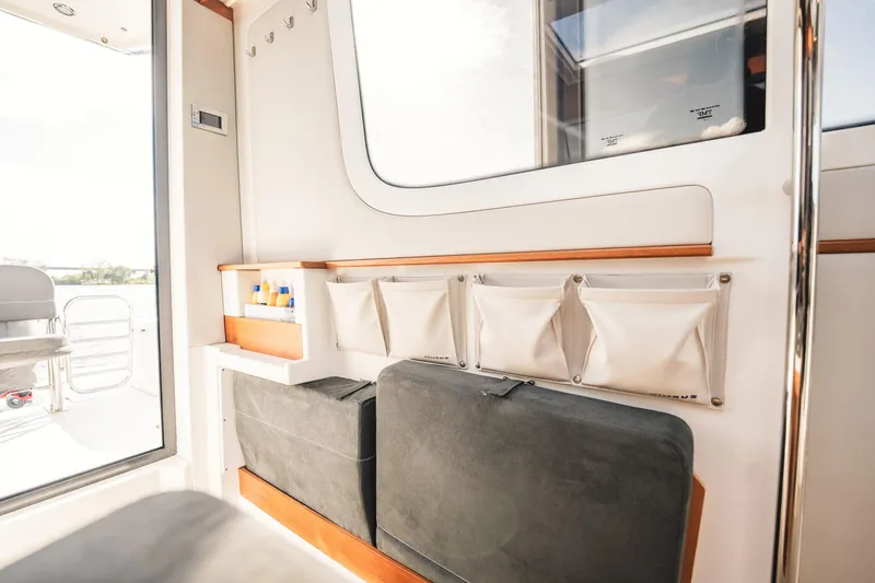Lady Lindy Yacht Photos Pics Interior of 2021 Nimbus C-11 boat with storage compartments and seating.