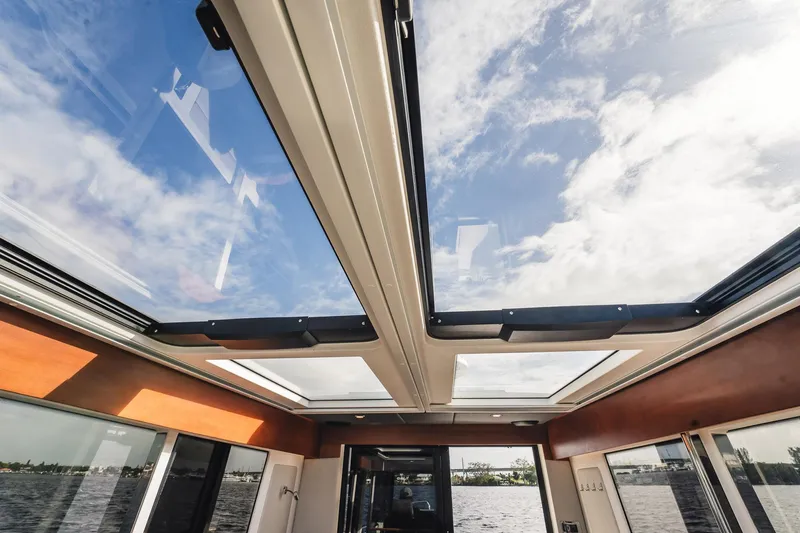 Lady Lindy Yacht Photos Pics 2021 Nimbus C-11 boat interior with panoramic sunroof and scenic water view.