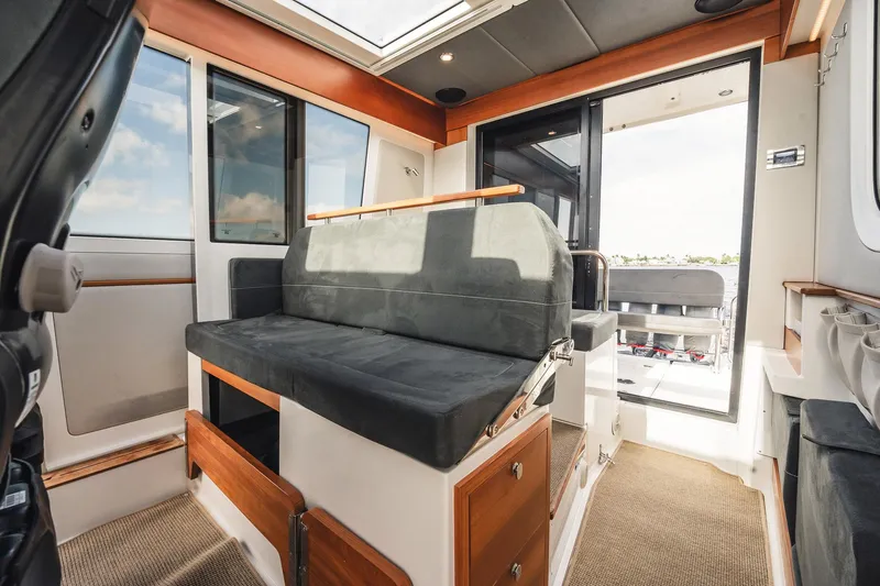 Lady Lindy Yacht Photos Pics Interior of 2021 Nimbus C-11 boat with modern seating and wooden accents.
