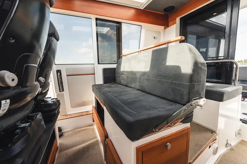 Lady Lindy Yacht Photos Pics Interior of 2021 Nimbus C-11 boat with cushioned seating and modern design.