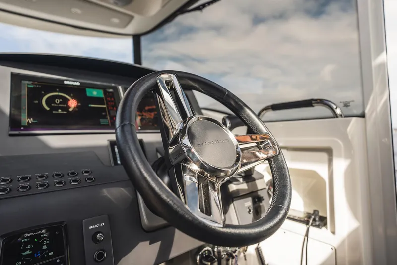 Lady Lindy Yacht Photos Pics Steering wheel and dashboard of 2021 Nimbus C-11 boat, featuring modern controls and displays.