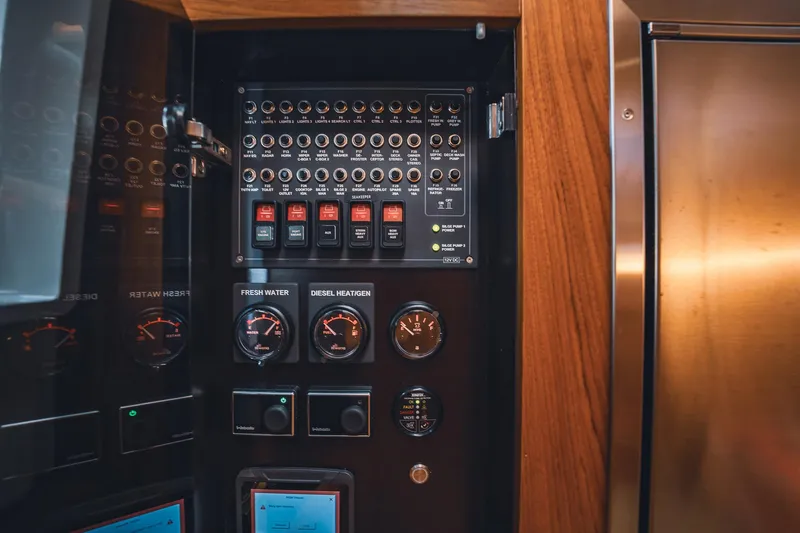 Lady Lindy Yacht Photos Pics Electrical control panel inside 2021 Nimbus C-11 boat, featuring gauges and switches.