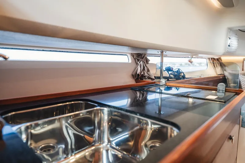 Lady Lindy Yacht Photos Pics Luxurious kitchen interior of 2021 Nimbus C-11 yacht with sleek countertops and stainless steel sink.