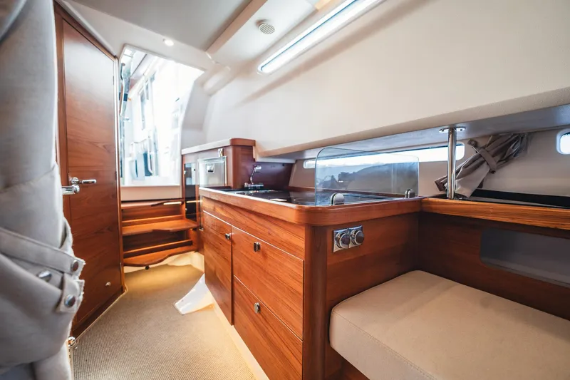 Lady Lindy Yacht Photos Pics Luxurious interior of 2021 Nimbus C-11 yacht with wooden cabinetry and seating.