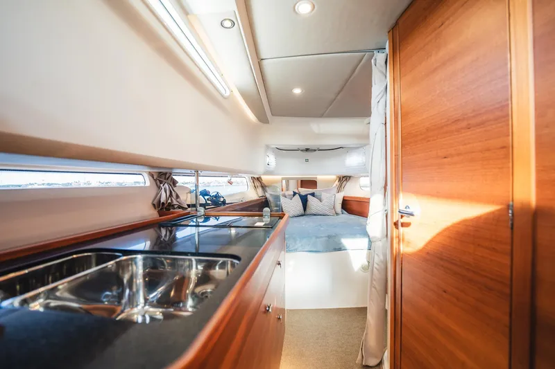 Lady Lindy Yacht Photos Pics Luxurious interior of 2021 Nimbus C-11 yacht with modern kitchen and cozy bedroom.