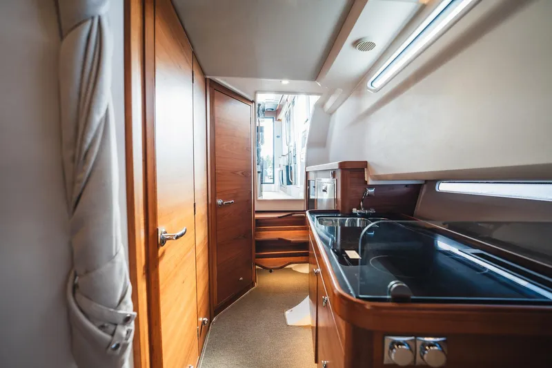 Lady Lindy Yacht Photos Pics Luxurious interior of 2021 Nimbus C-11 yacht with wooden cabinetry and modern amenities.