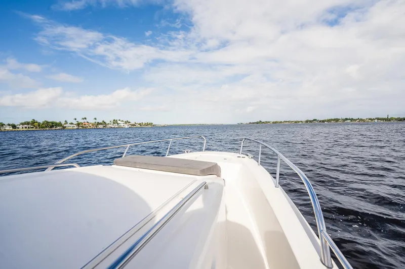 Lady Lindy Yacht Photos Pics Nimbus C-11 boat cruising on open water under a partly cloudy sky, 2021 model.