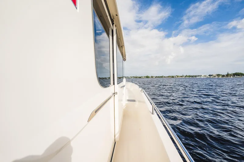 Lady Lindy Yacht Photos Pics 2021 Nimbus C-11 boat cruising on a sunny day with blue skies and calm waters.