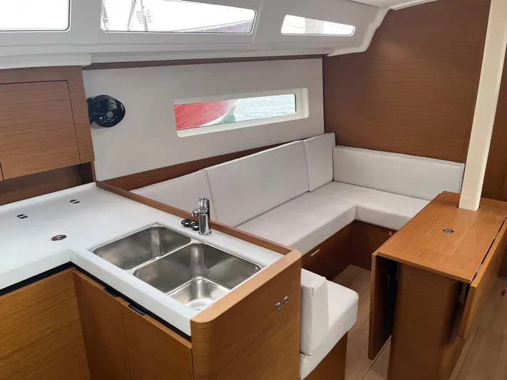 Resfeber Yacht Photos Pics Interior of 2023 Jeanneau Sun Odyssey 380 yacht with modern kitchen and seating area.