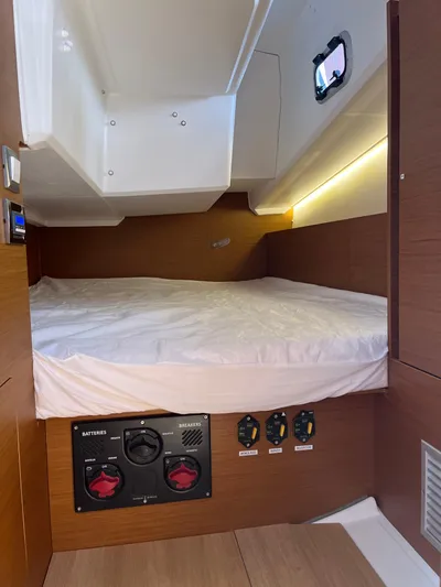 Resfeber Yacht Photos Pics 2023 Jeanneau Sun Odyssey 380 cabin interior with bed and control panel.