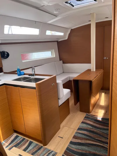 Resfeber Yacht Photos Pics 2023 Jeanneau Sun Odyssey 380 interior with modern kitchen and seating area.