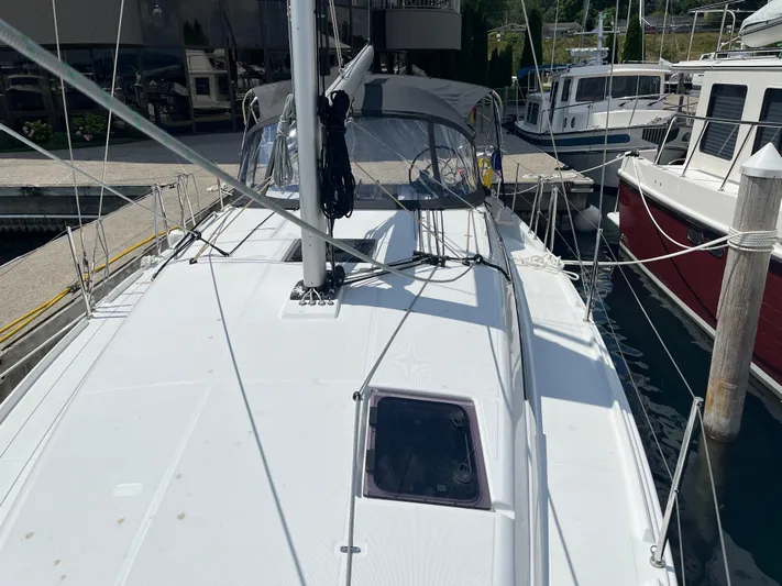 Resfeber Yacht Photos Pics 2023 Jeanneau Sun Odyssey 380 sailboat docked at marina, showcasing sleek deck design.