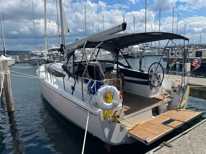 Resfeber Yacht Photos Pics 2023 Jeanneau Sun Odyssey 380 yacht docked at marina under cloudy sky.