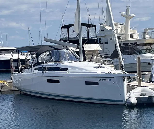 Resfeber Yacht Photos Pics 2023 Jeanneau Sun Odyssey 380 sailboat docked at marina, surrounded by other boats.