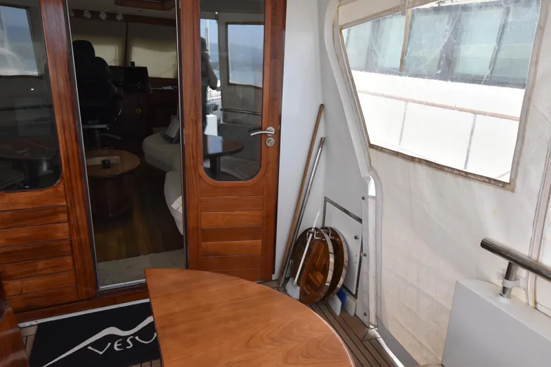 Vesuvio Yacht Photos Pics Interior view of a 2007 Pacific Prestige 170 yacht with wooden doors and seating area.