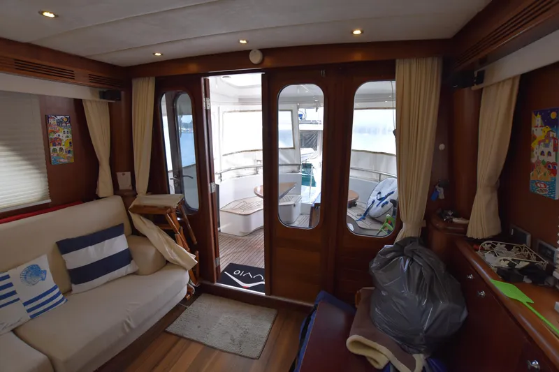 Vesuvio Yacht Photos Pics Interior of 2007 Pacific Prestige 170 yacht with cozy seating and wooden decor.