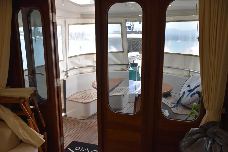 Vesuvio Yacht Photos Pics Interior view of 2007 Pacific Prestige 170 yacht, featuring wooden doors and a cozy seating area.